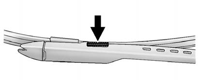 2. Squeeze the grooved areas on each side of the blade, and turn the blade assembly