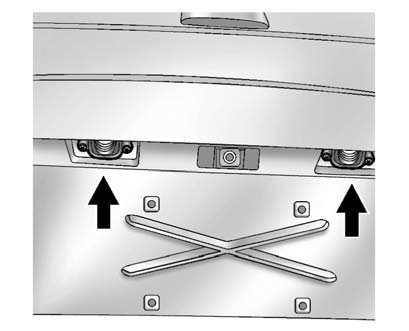 1. Remove the two screws holding each of the license plate lamps to the molding